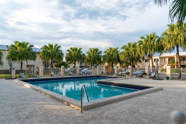a view of swimming pool with outdoor seating and plants
