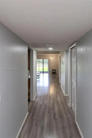 a view of hallway with wooden floor