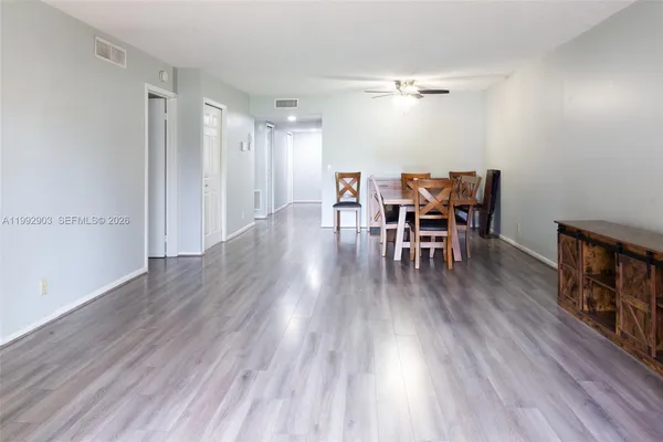 a dining room with furniture and wooden floor