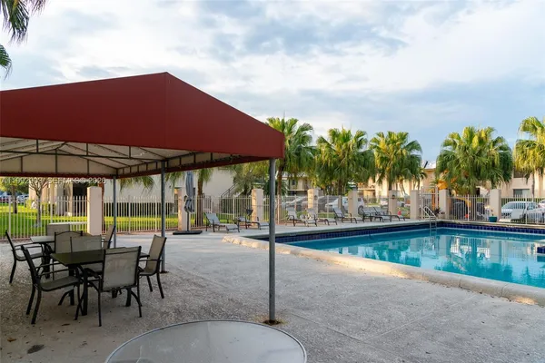 an outdoor space with furniture and umbrella