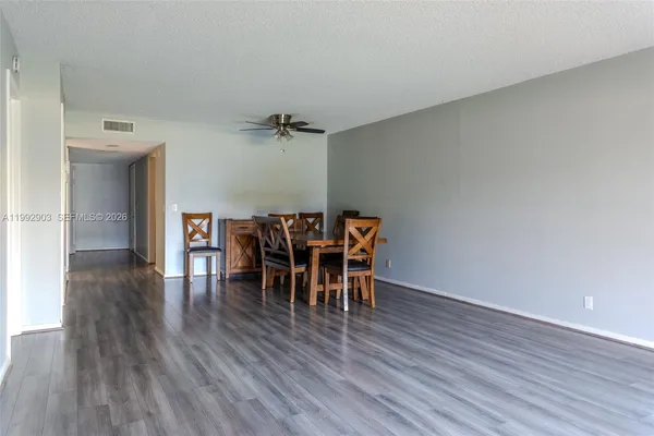 a view of a dining room with furniture and wooden floor