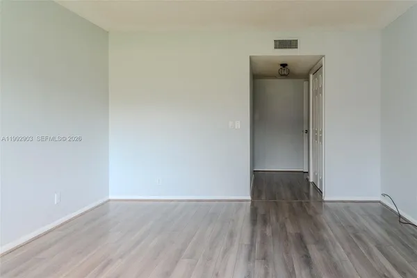 a view of an empty room and wooden floor