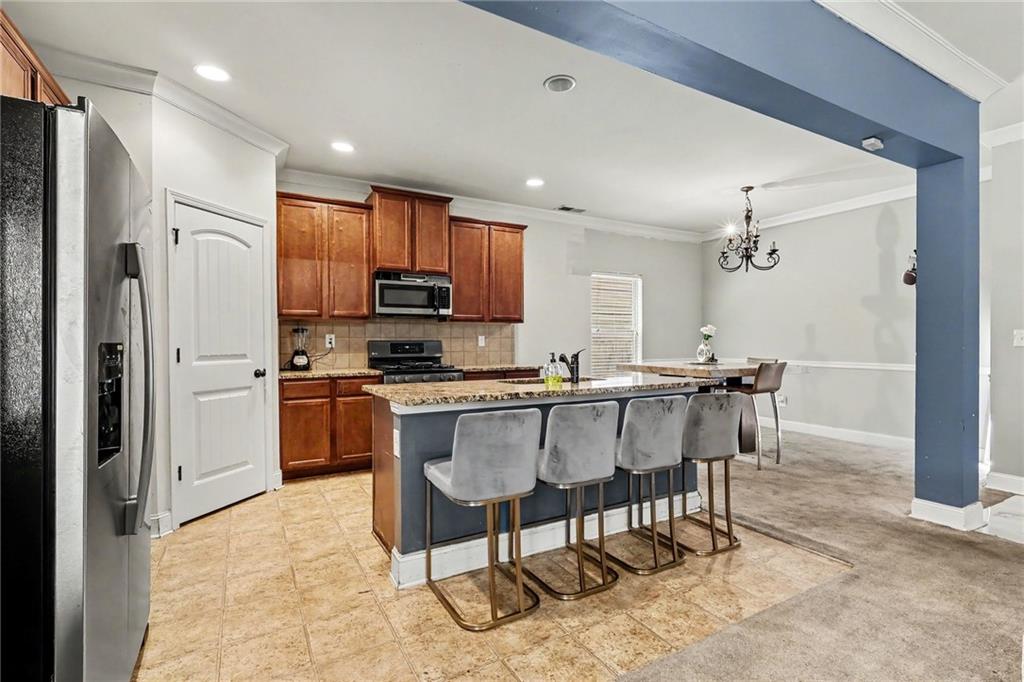 2780 Lakeview Walk Decatur, GA 30035 - Photo 11 of 37 a kitchen with stainless steel appliances kitchen island granite countertop a refrigerator and a stove top oven