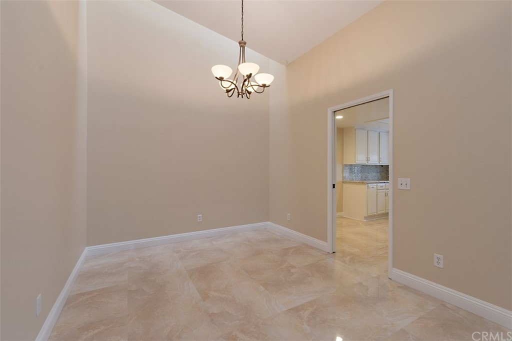 25666 Seaside Drive, Unit 134 Dana Point, CA 92629 - Photo 4 of 13 a view of a chandelier fan and hardwood floor