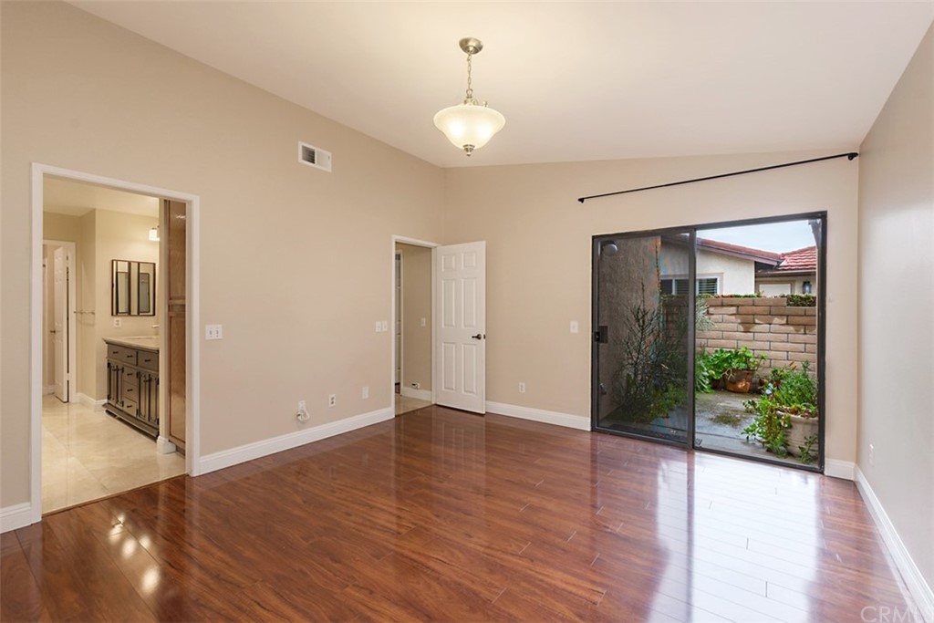 25666 Seaside Drive, Unit 134 Dana Point, CA 92629 - Photo 7 of 13 a view of an empty room with wooden floor and a window