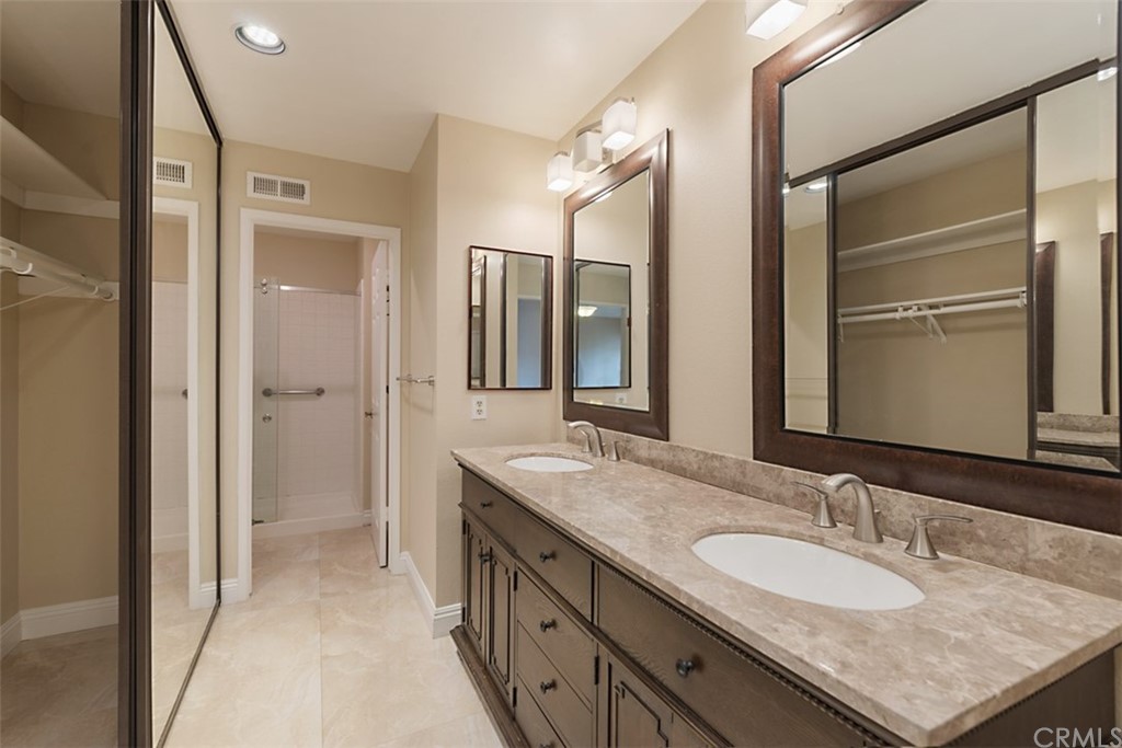 25666 Seaside Drive, Unit 134 Dana Point, CA 92629 - Photo 8 of 13 a bathroom with a granite countertop sink double and mirror
