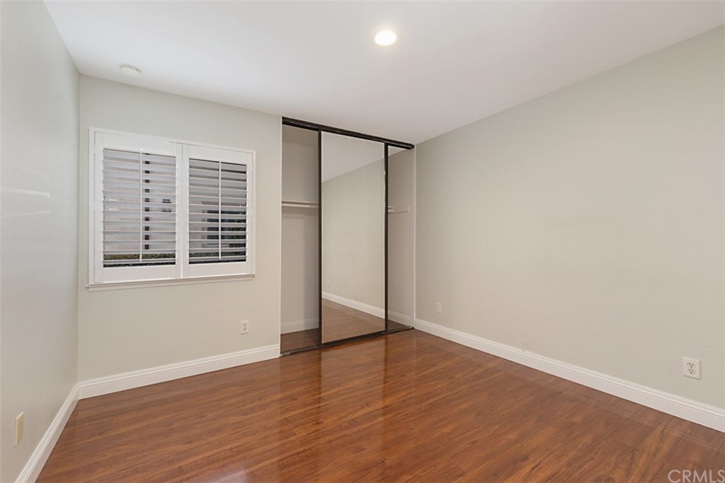 25666 Seaside Drive, Unit 134 Dana Point, CA 92629 - Photo 10 of 13 wooden floor in an empty room with a window