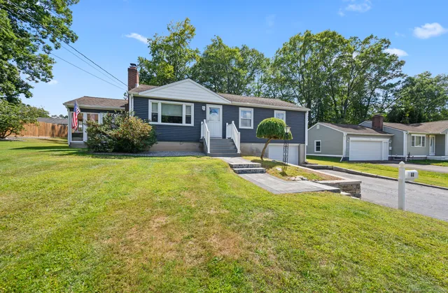 a view of a house with swimming pool and a yard