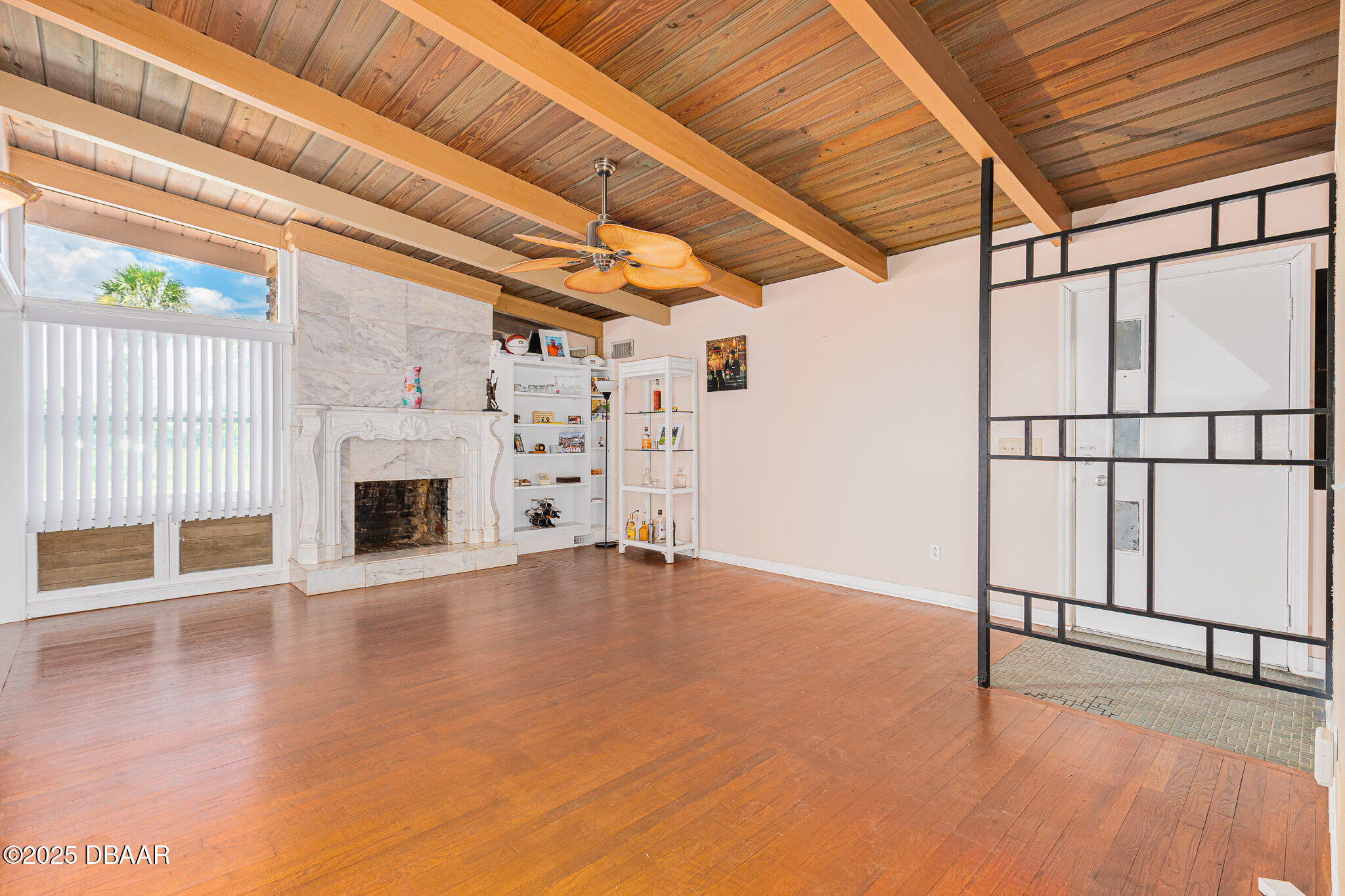 46 Oceanview Avenue Ponce Inlet, FL 32127 - Photo 6 of 79 a view of an empty room with a fireplace and a window
