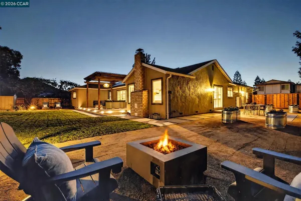 a view of a house with swimming pool and sitting area