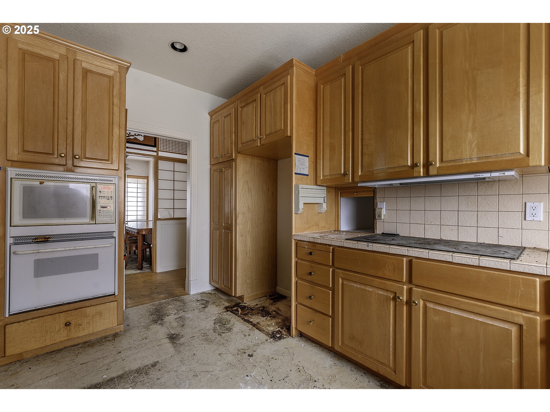 16333 Southwest Timberland Drive Beaverton, OR 97007 - Photo 7 of 42 a kitchen with stainless steel appliances granite countertop a refrigerator and cabinets