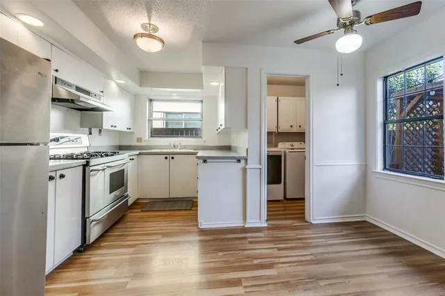 a kitchen with stainless steel appliances a stove top oven and cabinets