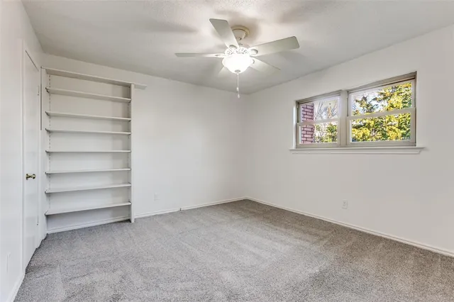 a view of room with window and ceiling fan