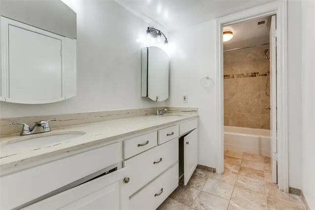 a bathroom with a granite countertop sink mirror and a