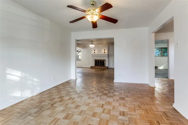 a view of a hallway with a chandelier fan and windows
