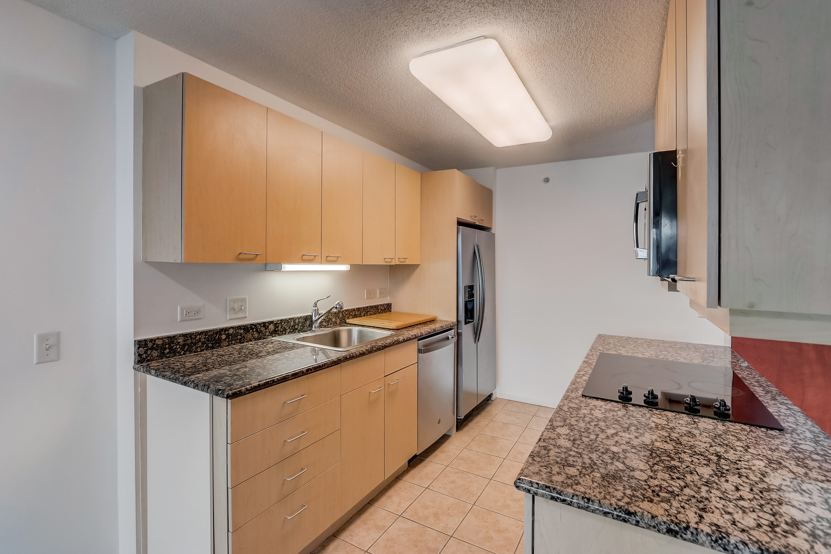 800 Elgin Road, Unit 1220 Evanston, IL 60201 - Photo 11 of 39 a kitchen with a stove a sink and a refrigerator