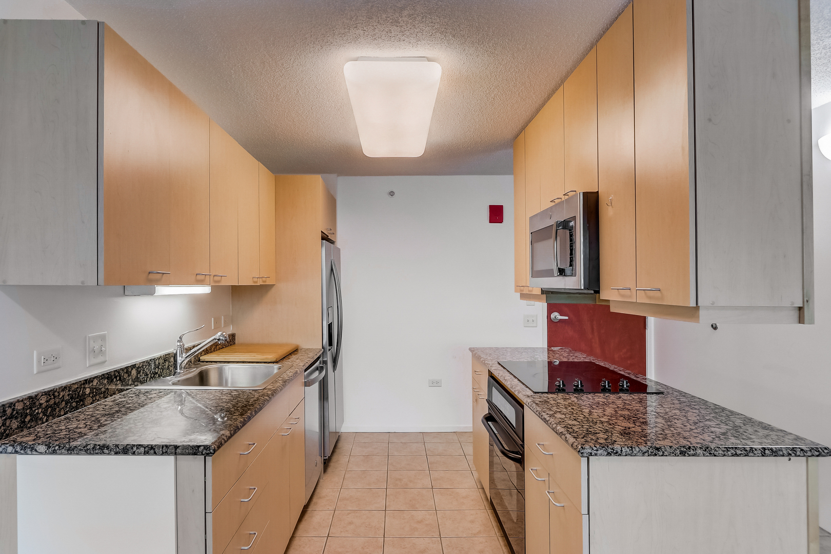 800 Elgin Road, Unit 1220 Evanston, IL 60201 - Photo 12 of 39 a kitchen with stainless steel appliances granite countertop a sink stove and cabinets