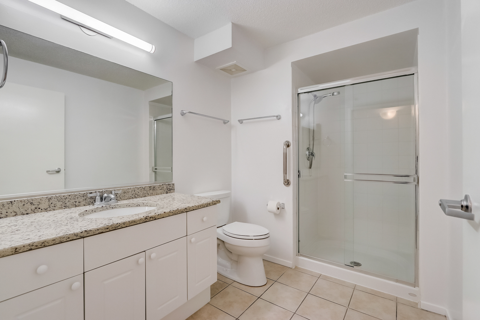 800 Elgin Road, Unit 1220 Evanston, IL 60201 - Photo 23 of 39 a bathroom with a granite countertop sink toilet and shower