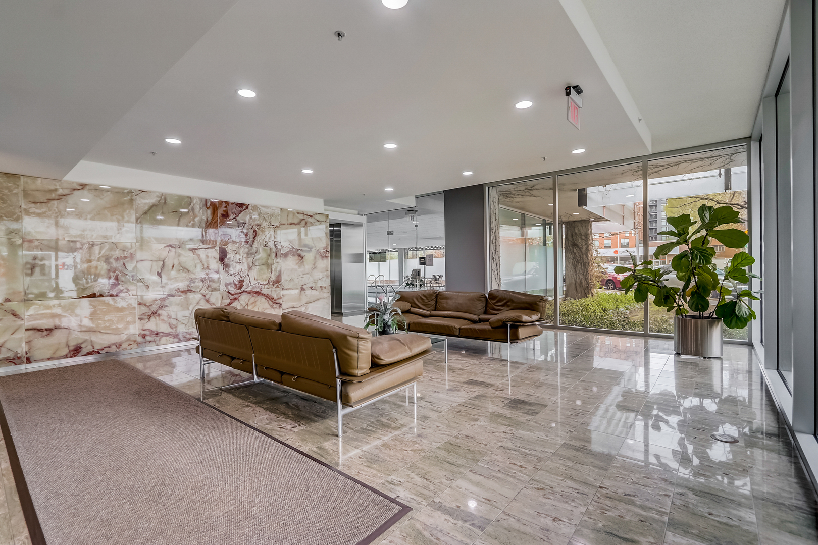 800 Elgin Road, Unit 1220 Evanston, IL 60201 - Photo 34 of 39 a living room with furniture and a potted plant
