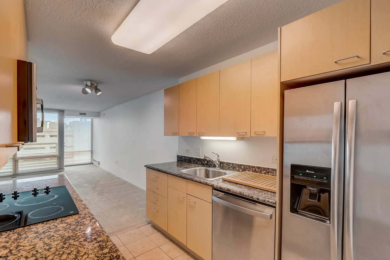 800 Elgin Road, Unit 1220 Evanston, IL 60201 - Photo 8 of 39 a kitchen with a refrigerator and a stove top oven