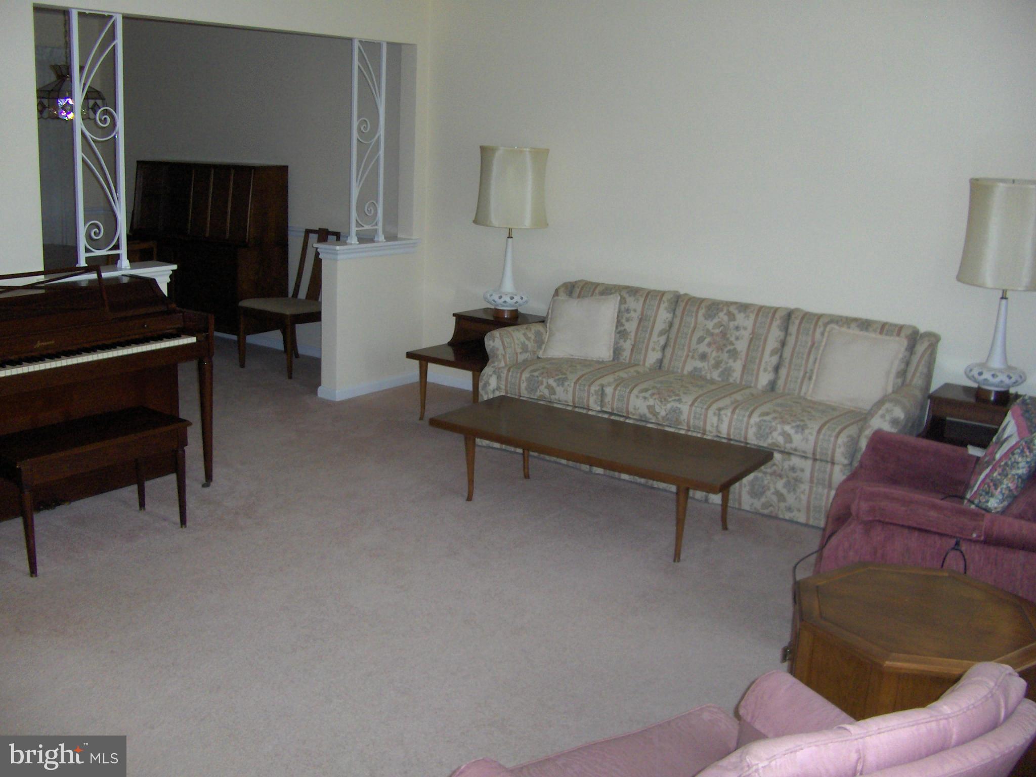 1421 Ray Road Hyattsville, MD 20782 - Photo 8 of 27 a living room with furniture and a piano