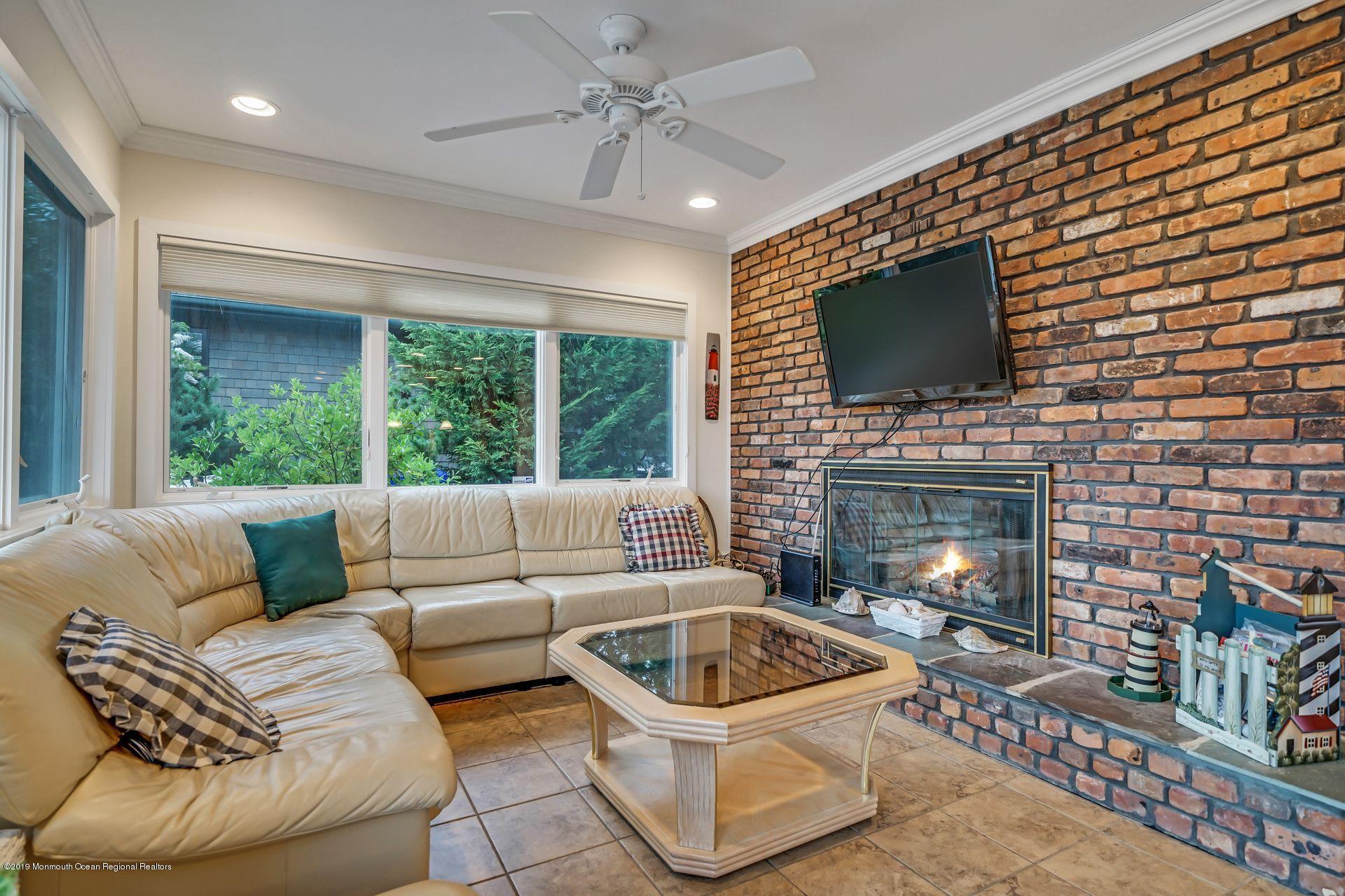 195 Ketch Road Mantoloking, NJ 08738 - Photo 12 of 44 a living room with furniture a flat screen tv and a fireplace