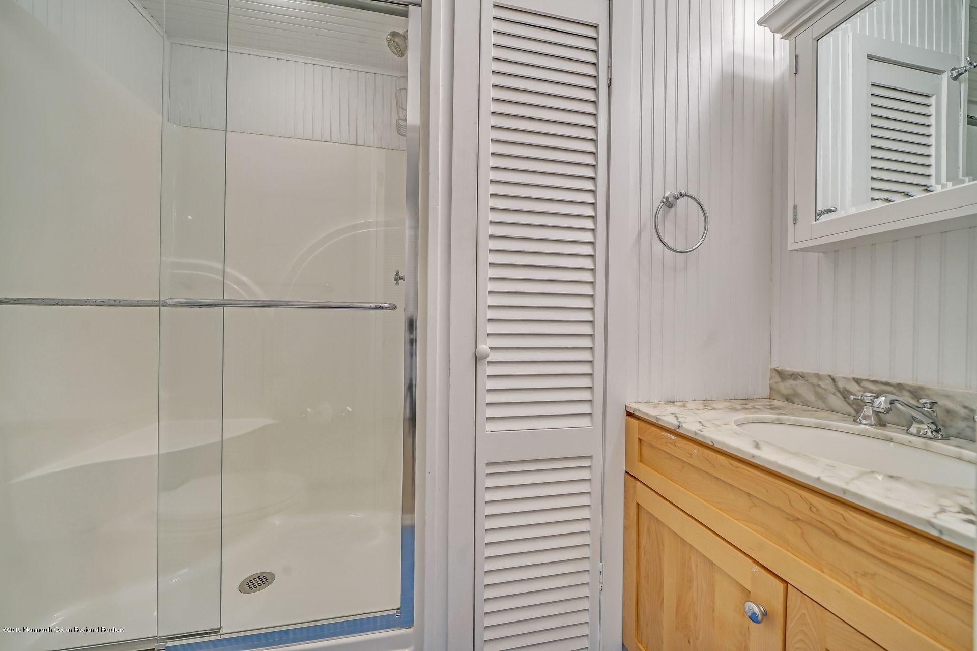 195 Ketch Road Mantoloking, NJ 08738 - Photo 20 of 44 a bathroom with a granite countertop sink and a mirror
