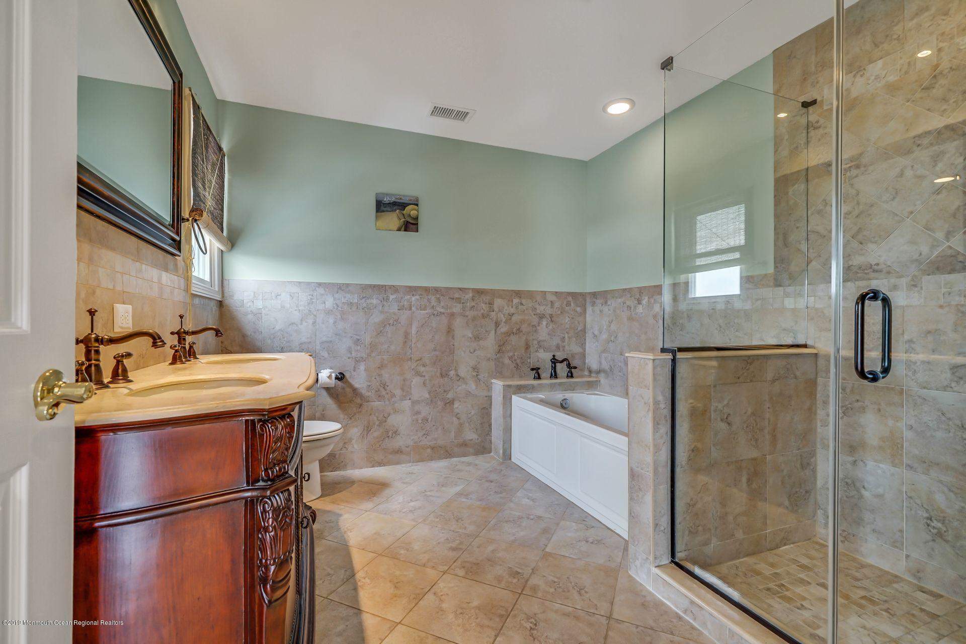 195 Ketch Road Mantoloking, NJ 08738 - Photo 29 of 44 a bathroom with a granite countertop sink a toilet and shower