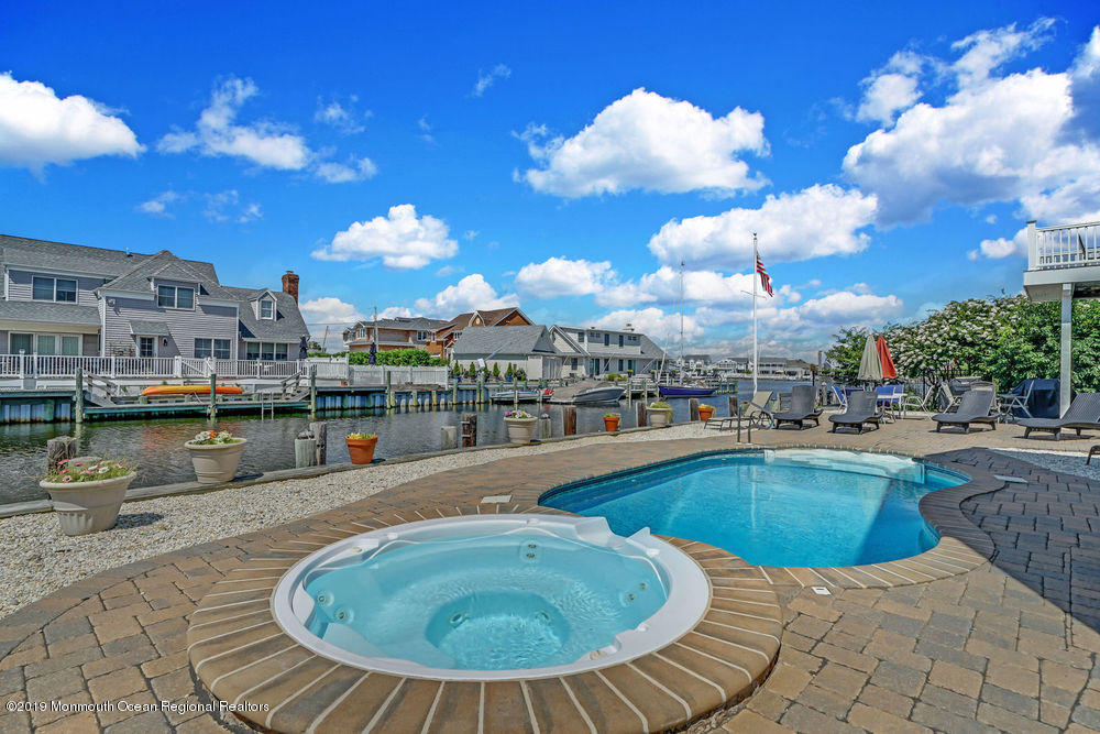 195 Ketch Road Mantoloking, NJ 08738 - Photo 3 of 44 a view of a swimming pool and a terrace