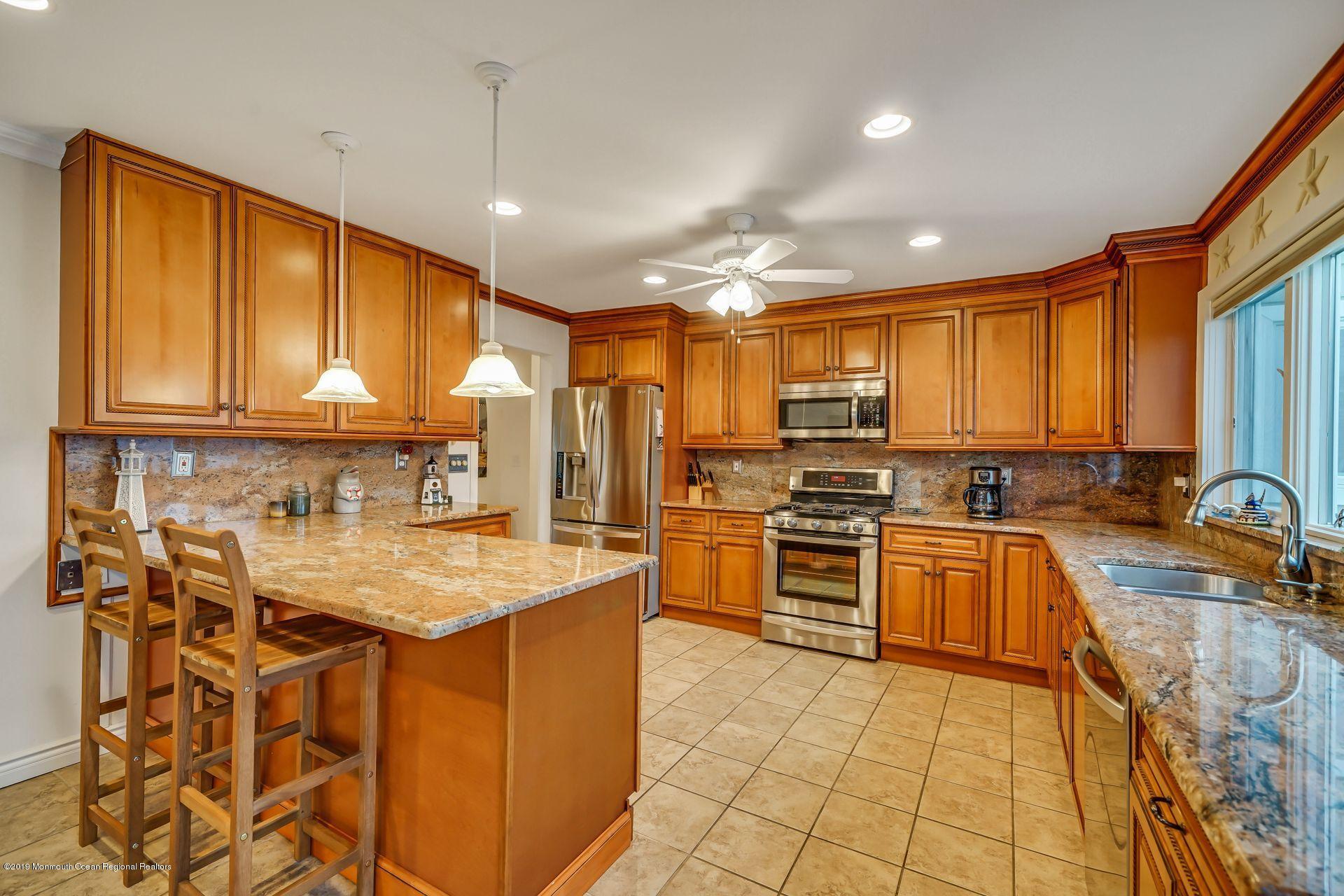 195 Ketch Road Mantoloking, NJ 08738 - Photo 8 of 44 a kitchen with stainless steel appliances granite countertop a sink counter space cabinets and a large window