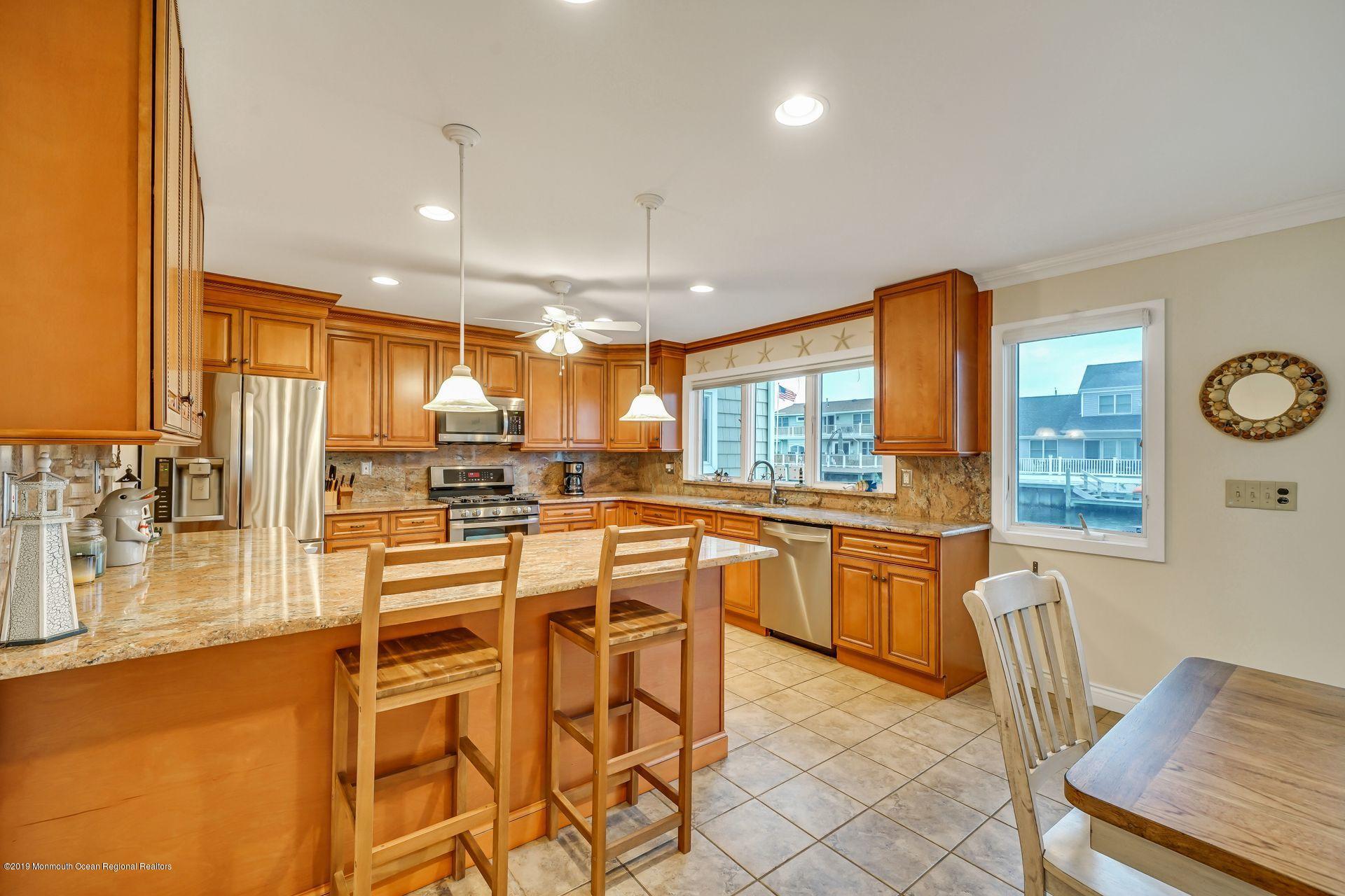 195 Ketch Road Mantoloking, NJ 08738 - Photo 9 of 44 a large kitchen with a table and chairs