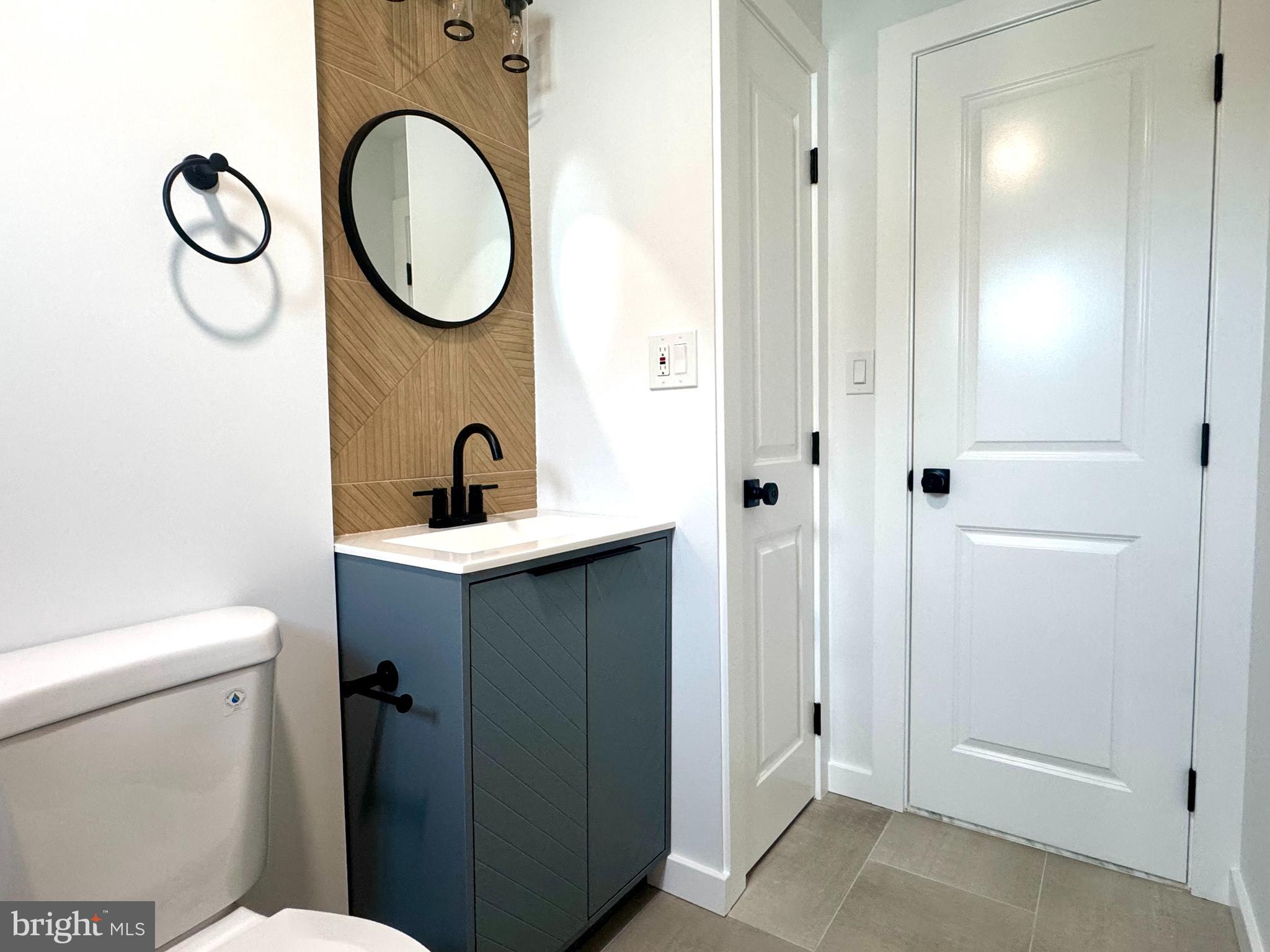 63 Gerard Road Hamilton, NJ 08620 - Photo 11 of 22 a bathroom with a toilet sink vanity and mirror