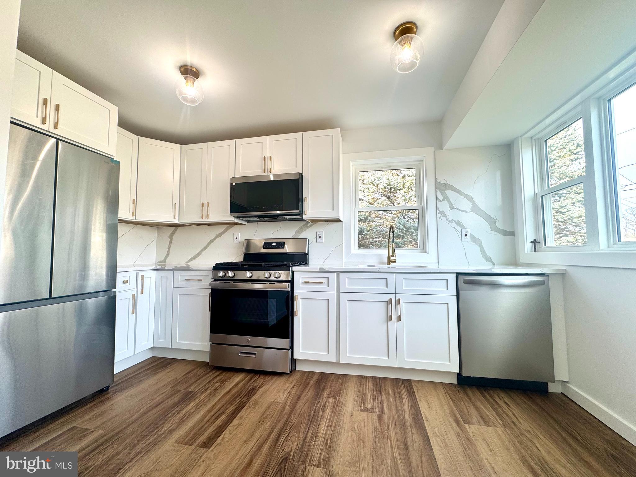 63 Gerard Road Hamilton, NJ 08620 - Photo 5 of 22 a kitchen with stainless steel appliances a refrigerator sink and microwave