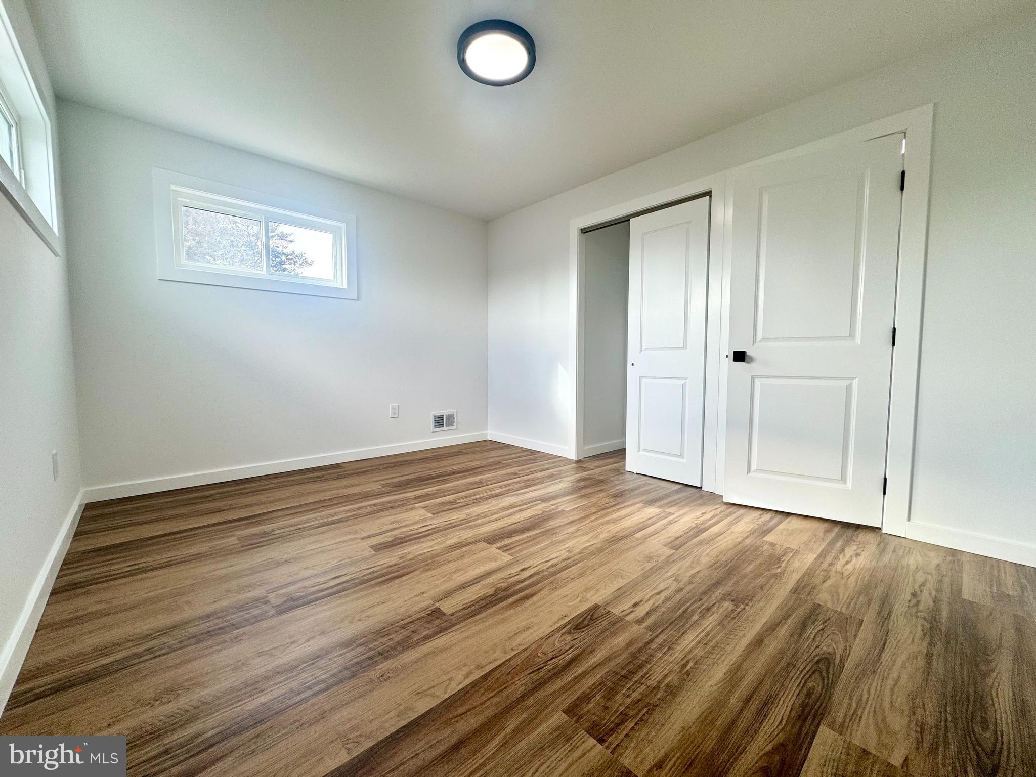 63 Gerard Road Hamilton, NJ 08620 - Photo 8 of 22 a view of empty room with wooden floor and fan