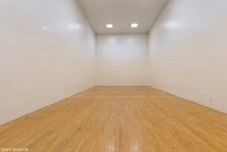 a view of hallway with a bathroom