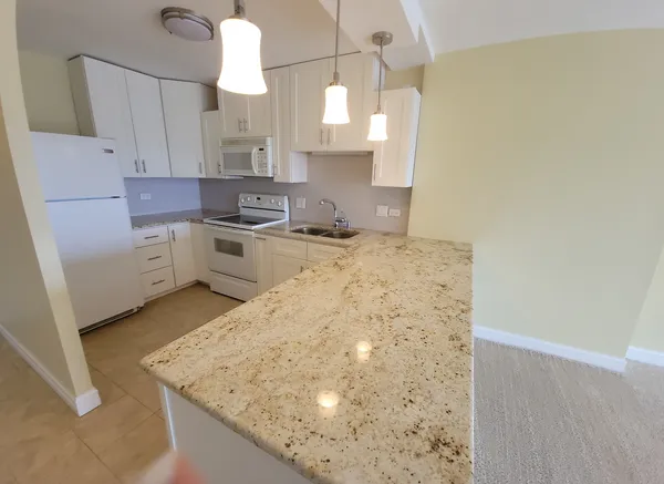 a kitchen with sink cabinets and window