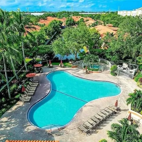 a view of a swimming pool with a yard