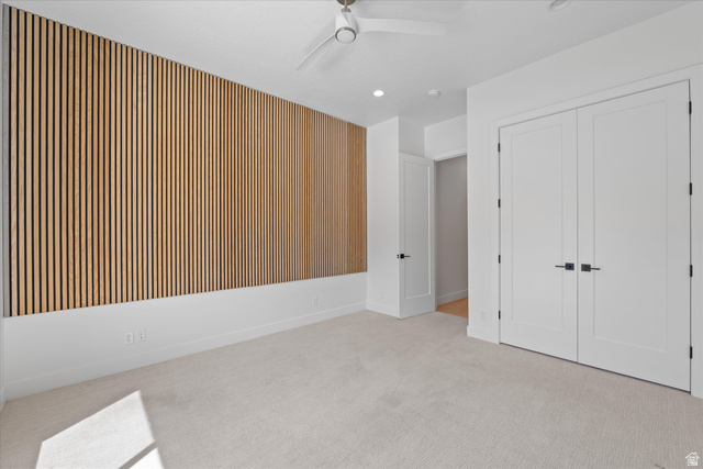 1192 East Corral Way Washington, UT 84780 - Photo 39 of 81 Spacious room featuring a prominent wood slat accent wall, plush carpeting, a contemporary ceiling fan, recessed lighting, and double panel doors with matte black hardware