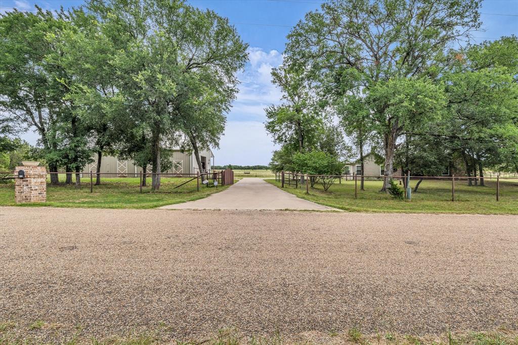 613 Bone Road Valley Mills, TX 76689 - Photo 2 of 40 a view of a house with a big yard and palm trees