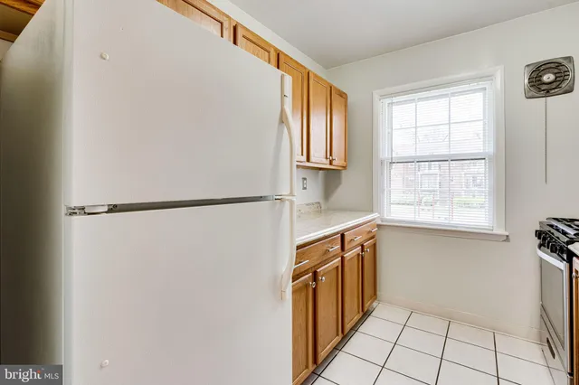 a stove top oven sitting inside of a kitchen