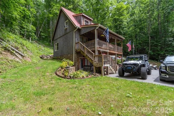 a view of house with backyard and seating area