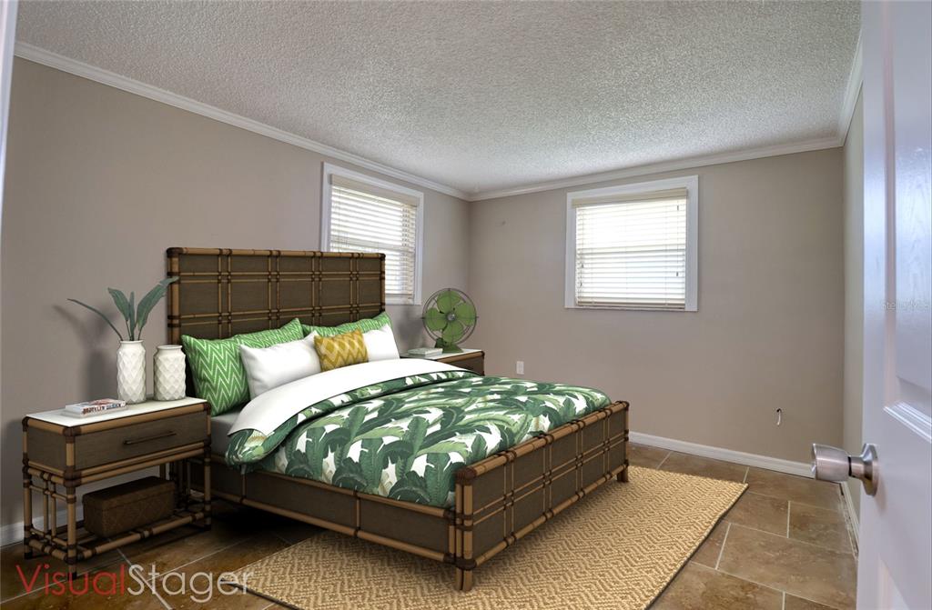 13637 Lagoon Drive Hudson, FL 34667 - Photo 22 of 36 a bed sitting in a bedroom next to a window