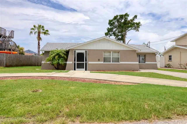 a front view of a house with a garden and yard