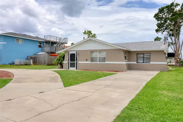 an aerial view of a house with outdoor space swimming pool and ocean view