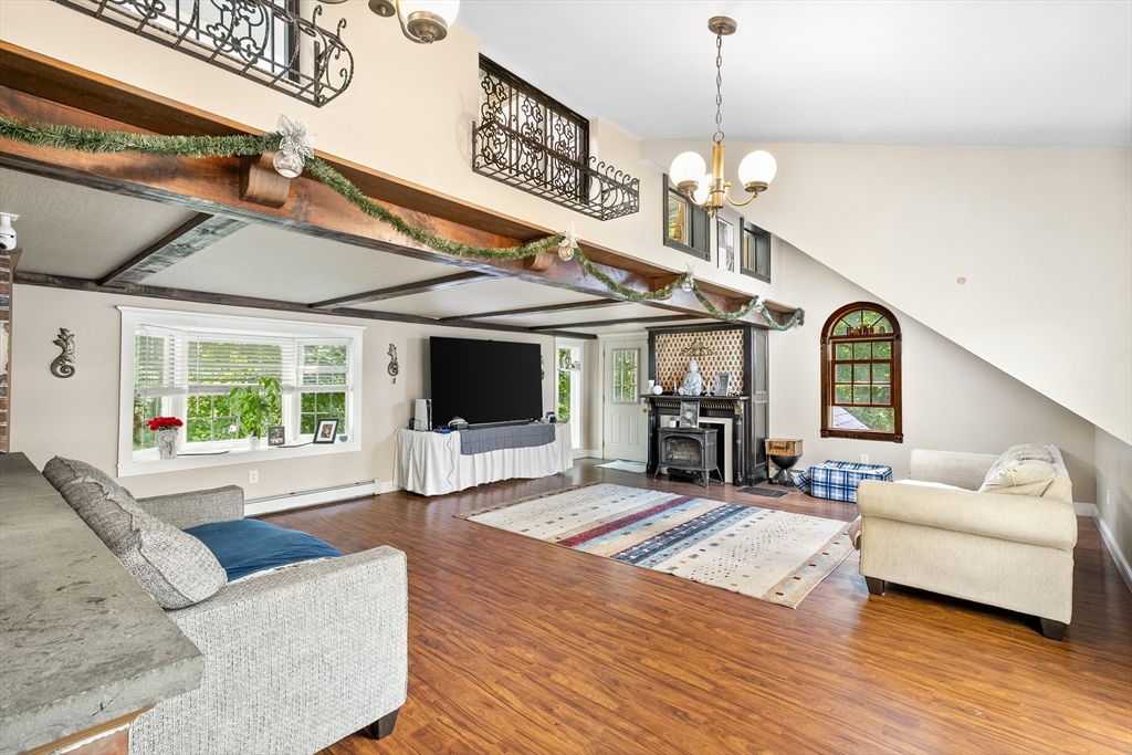 13 Coombs Street Southbridge, MA 01550 - Photo 11 of 41 a living room with furniture a fireplace and a flat screen tv