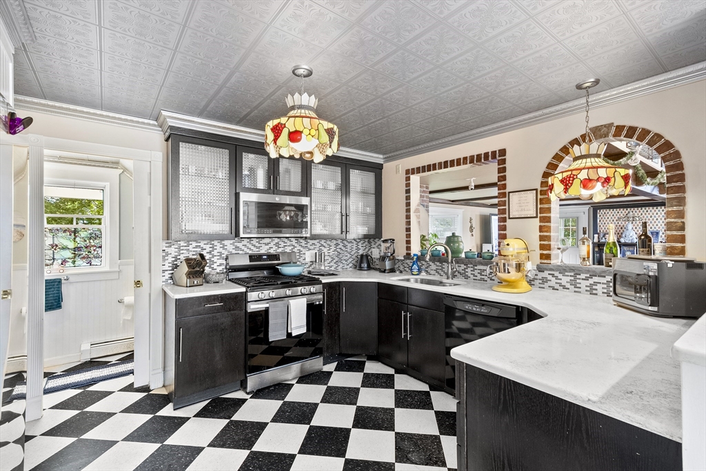 13 Coombs Street Southbridge, MA 01550 - Photo 12 of 41 a kitchen with a sink a stove and cabinets