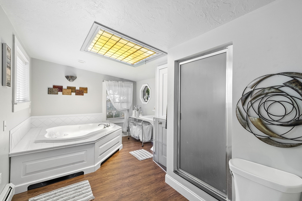 13 Coombs Street Southbridge, MA 01550 - Photo 35 of 41 a bathroom with a granite countertop sink and a bathtub