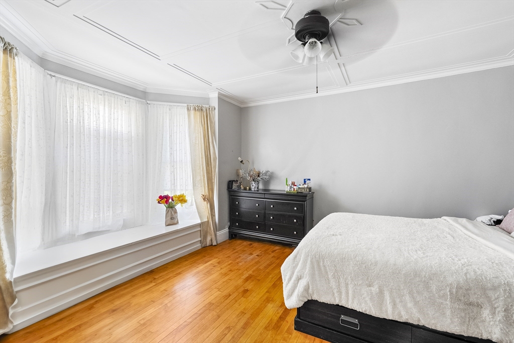 13 Coombs Street Southbridge, MA 01550 - Photo 39 of 41 a bedroom with a bed and a chandelier