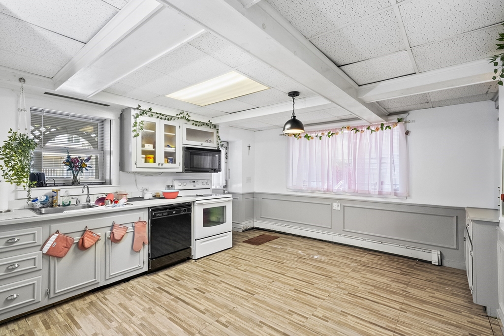 13 Coombs Street Southbridge, MA 01550 - Photo 41 of 41 a kitchen with stainless steel appliances a stove and wooden floor