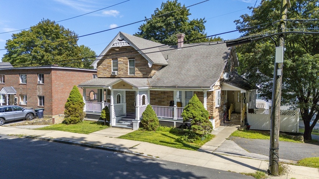 13 Coombs Street Southbridge, MA 01550 - Photo 8 of 41 a view of a house with small yard plants and a large tree
